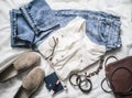 Summer womens fashion clothes set - mom`s jeans, suede sneakers, cotton t-shirt, bag, bracelets, lipstick on a light