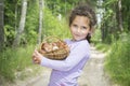 In the summer in the woods a little girl collected a basket of m Royalty Free Stock Photo