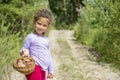 In the summer in the woods a little girl collected a basket of m Royalty Free Stock Photo