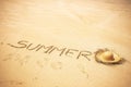 Summer word written on the sand at the beach in tropical scenic place for holiday vacation people concept - tourist hat for Royalty Free Stock Photo