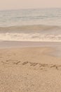 Summer written in soft wet sand on a beach, Dubai-1 September 2017