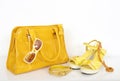 Summer yellow bag with matching sandals and accessories. Royalty Free Stock Photo