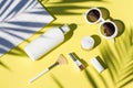 Summer yellow cosmetics flat lay with sunglasses. Top view beauty