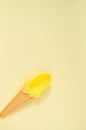 Summer yellow ice cream spoon on yellow background