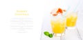 Summer yellow orange lemonade with ice and blood oranges and straw on a wooden table on a white background Royalty Free Stock Photo