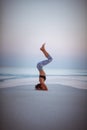 Summer yoga session on a beautiful golden beach of Maldives yoga tour, Salamba Sirsasana - supported headstand Royalty Free Stock Photo