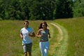 Summer - Young couple jogging in the meadow Royalty Free Stock Photo