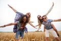 Happy hippie friends having fun on cereal field Royalty Free Stock Photo