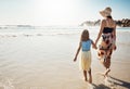 Summers here and fun is on the horizon. Rear view shot of a mother and her little daughter bonding together at the beach Royalty Free Stock Photo