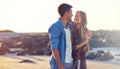 Summers here and that means romantic strolls on the beach. a happy young couple going for a walk along the beach. Royalty Free Stock Photo