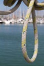 Summertime closeup of sailing rope with sailing boats in harbour