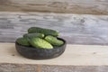 Summertime with fresh green cucumbers in unique handmade ceramic bowl decorated with Baltic folk signs