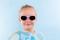 Summertime. Girl with ball and sunglasses isolated. Royalty Free Stock Photo