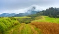 Summertime landscape with dirt road and view at covered with white clouds mount Velky Choc Great Choc in the Slovakia Royalty Free Stock Photo