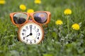 Summertime - orange sunglasses and alarm clock Royalty Free Stock Photo