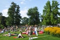 Summertime: people in ZÃÂ¼rich Seefeld lake promenade and park are taking a sun bath or a swim