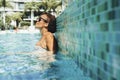 Summertime with pretty female enjoying relax in the water of the pool. People relaxing on poolside and enjoying the sun. Travel Royalty Free Stock Photo