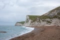 Cloudy day on Durdle door beach in the summertime. Royalty Free Stock Photo