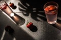 Summertime strawberry cocktail. A refreshing mix of strawberries, ice cubes, and a touch of mint. glass on a dark