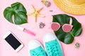 Summertime and travel feminine accessories on pink background. Flat lay