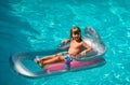 Summertime vacation. Child in pool. Boy swimming at swimmingpool. Funny kid on inflatable rubber mattress. Royalty Free Stock Photo