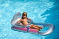 Summertime vacation. Child in pool. Boy swimming at swimmingpool. Funny kid on inflatable rubber mattress. Royalty Free Stock Photo