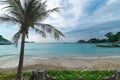 Amazing tropical scenery with boat waiting on a pure transparent clear green water on a white sand shore of a lagoon Royalty Free Stock Photo