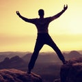 Summit achievemnt. Hiker in black celebrate triumph Royalty Free Stock Photo