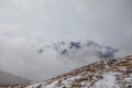 Summit of Cima Undici emerging from the clouds on a cloudy morning, South Tyrol Royalty Free Stock Photo