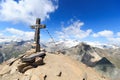 Summit cross and prayer flag on mountain Kreuzspitze with glacier panorama and Grossvenediger, Hohe Tauern Alps, Austria Royalty Free Stock Photo