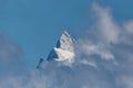 Summit of Finsteraarhorn mountain in clouds, blue sky Royalty Free Stock Photo