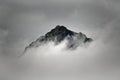 Summit of a mountain in the clouds Royalty Free Stock Photo