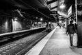 Summit, NJ USA - November 1, 2017: A hip and fashionable man in hat and sport coat exists NJ Transit train station at night, blac