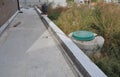 A sump pump, septic tank in the back yard of the house