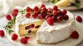 Elegant brie cheese with grapes and raspberries on a bright background Royalty Free Stock Photo