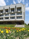 Flowerbed with tulips in front of the Sumy Oblast Universal Scientific Library named after Nadezhda Krupskaya, vertical