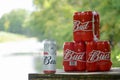 Budweiser Bud beer cans on old wooden table outdoors at the river and green trees background Royalty Free Stock Photo
