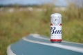 SUMY, UKRAINE - AUGUST 01, 2021: Can of Budweiser Lager Alcohol Beer on overturned kayak boat outdoors. Budweiser is a Brand from Royalty Free Stock Photo