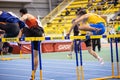 SUMY, UKRAINE - FEBRUARY 21, 2020: athletes run 60m hurdles sprint race at Ukrainian indoor track and field championship Royalty Free Stock Photo