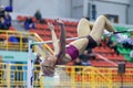 SUMY, UKRAINE - FEBRUARY 9, 2018: MAKSIMOVA Yana performing high jump in pentathlon of Ukrainian indoor track and field Royalty Free Stock Photo