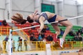 SUMY, UKRAINE - FEBRUARY 17, 2017: young sportswoman jumping over bar in qualification High Jump competition of Royalty Free Stock Photo