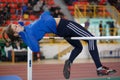 SUMY, UKRAINE - FEBRUARY 17, 2017: young sportswoman jumping over bar in qualification High Jump competition of Royalty Free Stock Photo