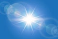 Sunny blue summer background with bright sun and lens flare Royalty Free Stock Photo