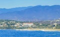 Sun beach cliffs rocks waves palms mountains Puerto Escondido Mexico