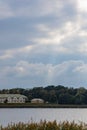 Sun beams through clouds over shiny big lake Royalty Free Stock Photo