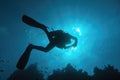 Sun beams shinning underwater and Scuba diver silhouette in the blue water Royalty Free Stock Photo