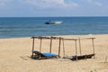 Beach sun beds blue ocean fishing boat, Hoi, Vietnam Royalty Free Stock Photo