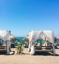 Sun beds on sandy beach coast, luxury Mediterranean resort as travel destination