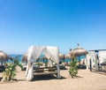 Sun beds on sandy beach coast, luxury Mediterranean resort as travel destination