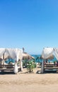 Sun beds on sandy beach coast, luxury Mediterranean resort as travel destination